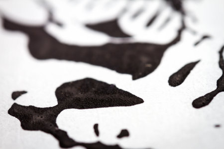 Extreme close up of black acrylic paint texture on paper. Selective focus.の写真素材