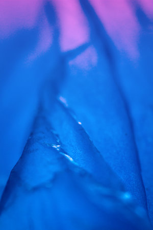 Extreme close up of blue empty plastic bag background. The plastic surface is wrinkly and tattered...