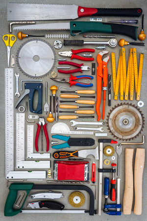 Flat lay of old hand tools on white background. Large collection of various rusty tools and bits arranged on white.の写真素材