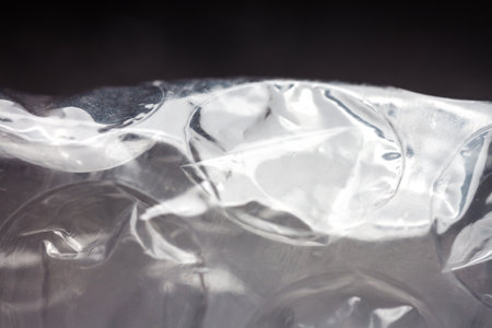 Extreme macro of plastic bubble wrap texture. Selective soft focus, shallow depth of field. Abstract dreamy backgroundの写真素材