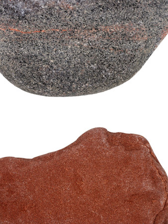 Edges of two pebbles isolated on white background with a space for textの写真素材