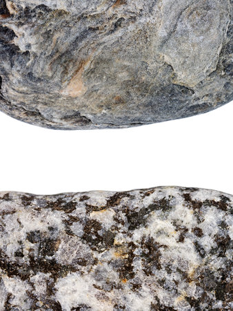 Edges of two pebbles isolated on white background with a space for textの写真素材