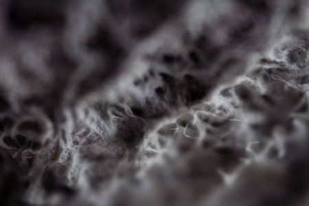 Extreme close up of old gray handmade paper clay with a structure and rough texture. Paper recycling. Selective soft focus, shallow depth of field.の写真素材