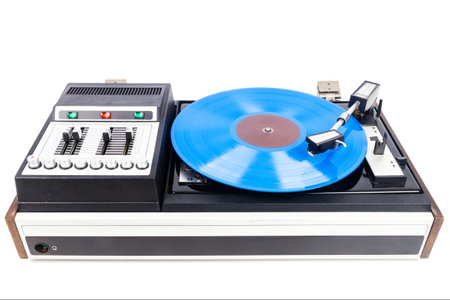 Vintage turntable record player with blue vinyl isolated on white background.の写真素材
