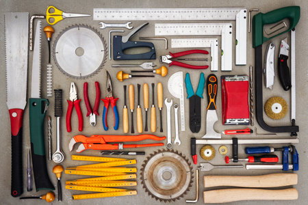 Flat lay of old hand tools on concrete background. Large collection of various rusty tools and bits...