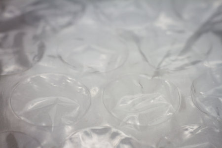 Extreme macro of plastic bubble wrap texture. Selective soft focus, shallow depth of field. Abstract dreamy backgroundの写真素材