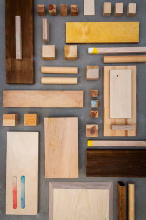 Flat lay of various wood and plywood pieces on concrete texture. Carpentry background.の写真素材