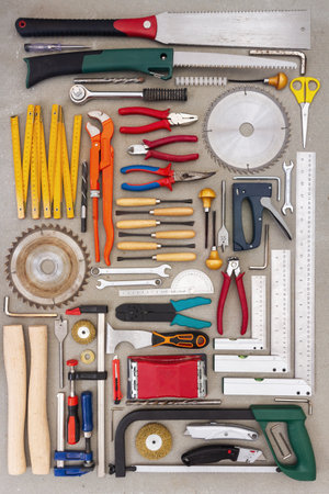Flat lay of old hand tools on concrete background. Large collection of various rusty tools and bits...