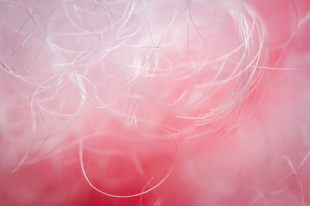 Extreme macro of polyester stable fiber on red background. Selective focus, shallow depth of field....