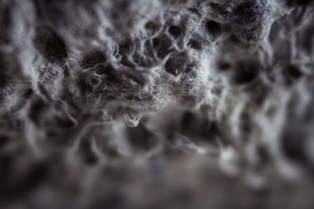 Extreme close up of old gray handmade paper clay with a structure and rough texture. Paper recycling. Selective soft focus, shallow depth of field.の写真素材