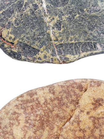 Edges of two pebbles isolated on white background with a space for textの写真素材