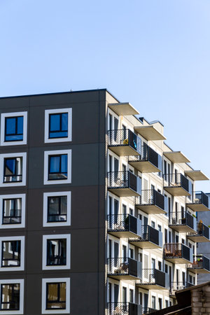 Contemporary building facade with some balconies. Close up of a modern apartment building.