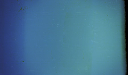 Blank grained film strip texture background with heavy grain, dust and light leakの写真素材