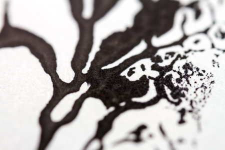 Extreme close up of black acrylic paint texture on paper. Selective focus.の写真素材