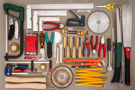 Flat lay of old hand tools on concrete background. Large collection of various rusty tools and bits...