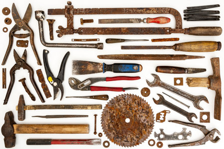 Flat lay of old hand tools on white background. Large collection of various rusty tools and bits...