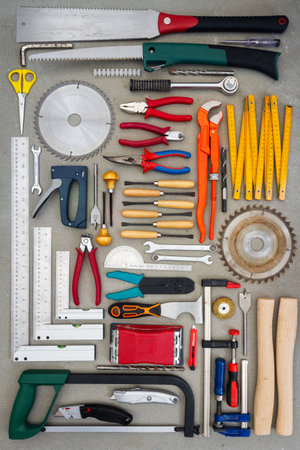 Flat lay of old hand tools on concrete background. Large collection of various rusty tools and bits...