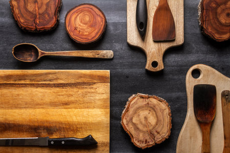 Wood log tree slices and cutting boards on black background. Flat lay. Top viewの写真素材