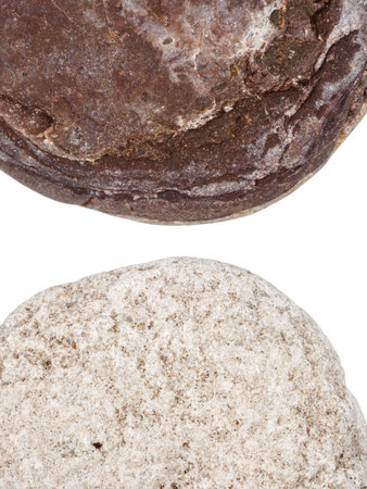 Edges of two pebbles isolated on white background with a space for text
