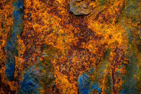 Rusty metal surface with shabby background paint. Blue cracked paint texture on an iron sheet....