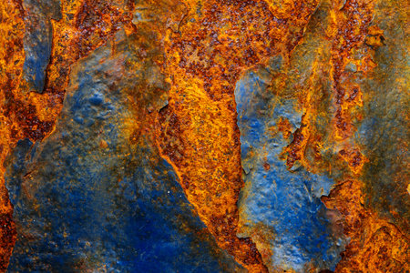 Rusty metal surface with shabby background paint. Blue cracked paint texture on an iron sheet. Fragment of an old metal door, Metal corrosion.の写真素材