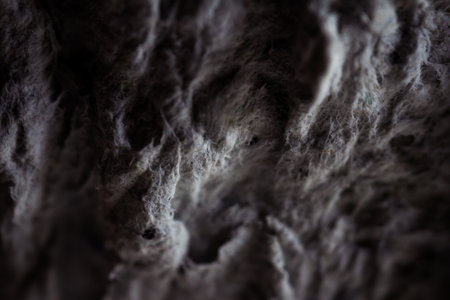 Extreme close up of old gray handmade paper clay with a structure and rough texture. Paper recycling. Selective soft focus, shallow depth of field.の写真素材