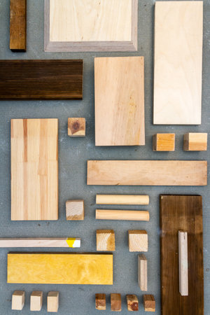 Flat lay of various wood and plywood pieces on concrete texture. Carpentry background.の写真素材