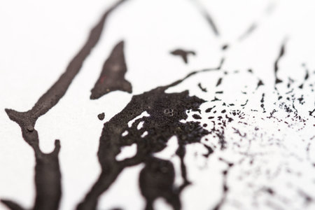 Extreme close up of black acrylic paint texture on paper. Selective focus.の写真素材
