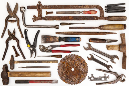 Flat lay of old hand tools on white background. Large collection of various rusty tools and bits arranged on white.の写真素材