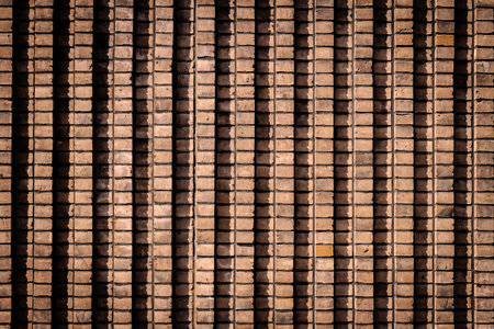 Background of old brown lined brick wall texture, abstract architecture wallpaper.