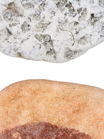 Edges of two pebbles isolated on white background with a space for textの写真素材