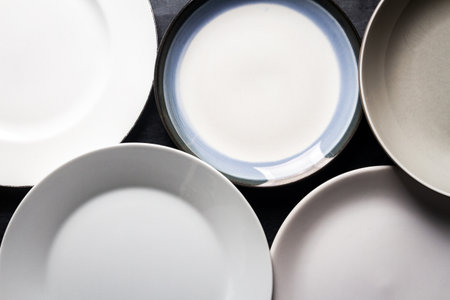 Top view of an empty plates and bowls placed on a black chalkboard background. Flat lay. Top view. Food concept.の写真素材