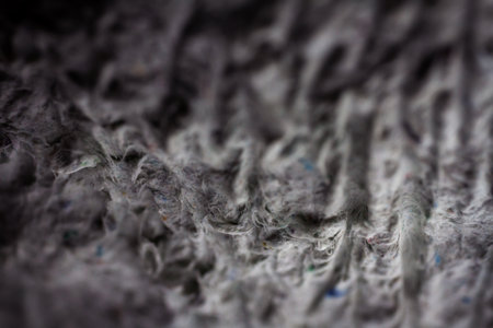 Extreme close up of old gray handmade paper clay with a structure and rough texture. Paper recycling. Selective soft focus, shallow depth of field.の写真素材