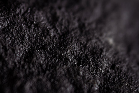 Extreme close up of old black handmade paper clay with a structure and rough texture. Paper recycling. Selective soft focus, shallow depth of field.の写真素材