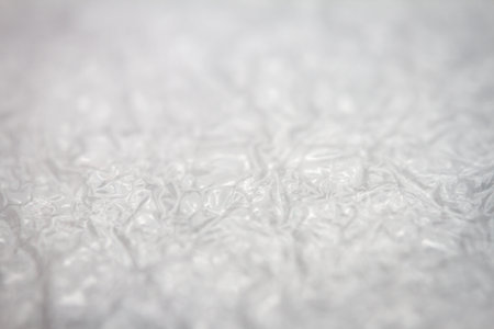 Extreme macro of plastic bubble wrap texture. Selective soft focus, shallow depth of field. Abstract dreamy backgroundの写真素材