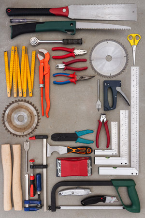 Flat lay of old hand tools on concrete background. Large collection of various tools and bits...
