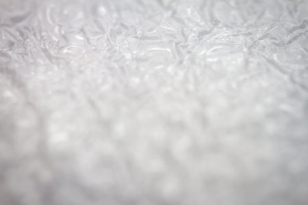 Extreme macro of plastic bubble wrap texture. Selective soft focus, shallow depth of field. Abstract dreamy backgroundの写真素材