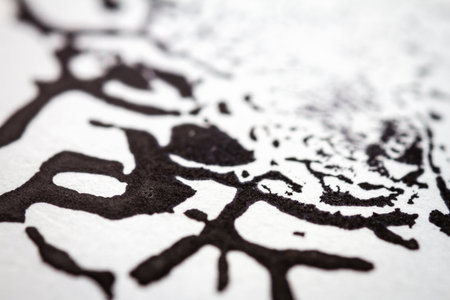 Extreme close up of black acrylic paint texture on paper. Selective focus.の写真素材