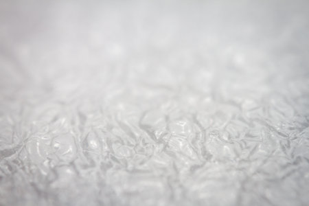 Extreme macro of plastic bubble wrap texture. Selective soft focus, shallow depth of field. Abstract dreamy backgroundの写真素材