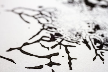 Extreme close up of black acrylic paint texture on paper. Selective focus.の写真素材