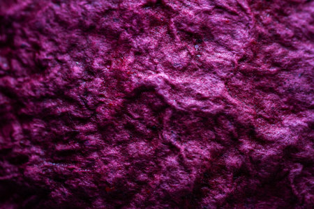 Extreme close up of purple handmade paper clay with a structure and rough texture. Paper recycling. Selective soft focus, shallow depth of field.の写真素材