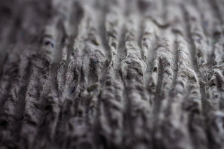 Extreme close up of old gray handmade paper clay with a structure and rough texture. Paper recycling. Selective soft focus, shallow depth of field.の写真素材