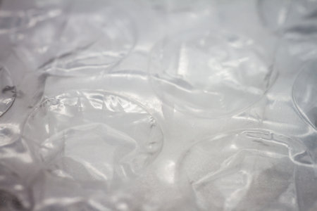 Extreme macro of plastic bubble wrap texture. Selective soft focus, shallow depth of field. Abstract dreamy backgroundの写真素材