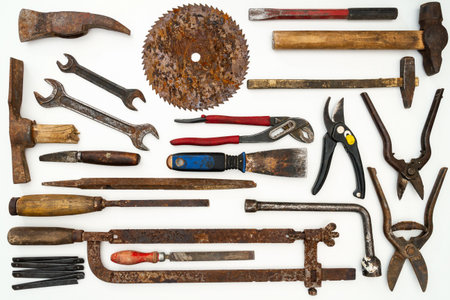 Flat lay of old hand tools on white background. Large collection of various rusty tools and bits...