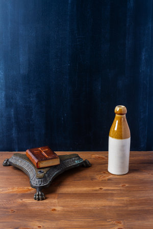 Various old vintage objects on brown wooden table by the black wall. Still life.の写真素材