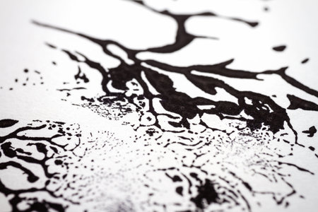 Extreme close up of black acrylic paint texture on paper. Selective focus.の写真素材