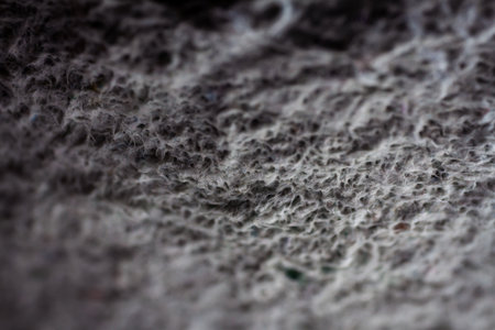 Extreme close up of old gray handmade paper clay with a structure and rough texture. Paper recycling. Selective soft focus, shallow depth of field.の写真素材