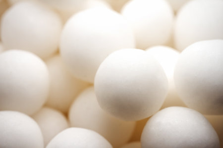 Extreme close up of white small peppermint candy balls. Selective soft focus, shallow depth of...