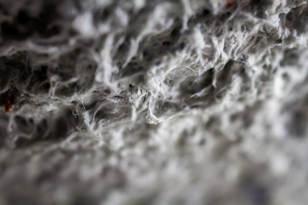 Extreme close up of old gray handmade paper clay with a structure and rough texture. Paper recycling. Selective soft focus, shallow depth of field.の写真素材