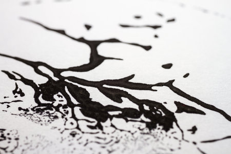 Extreme close up of black acrylic paint texture on paper. Selective focus.の写真素材